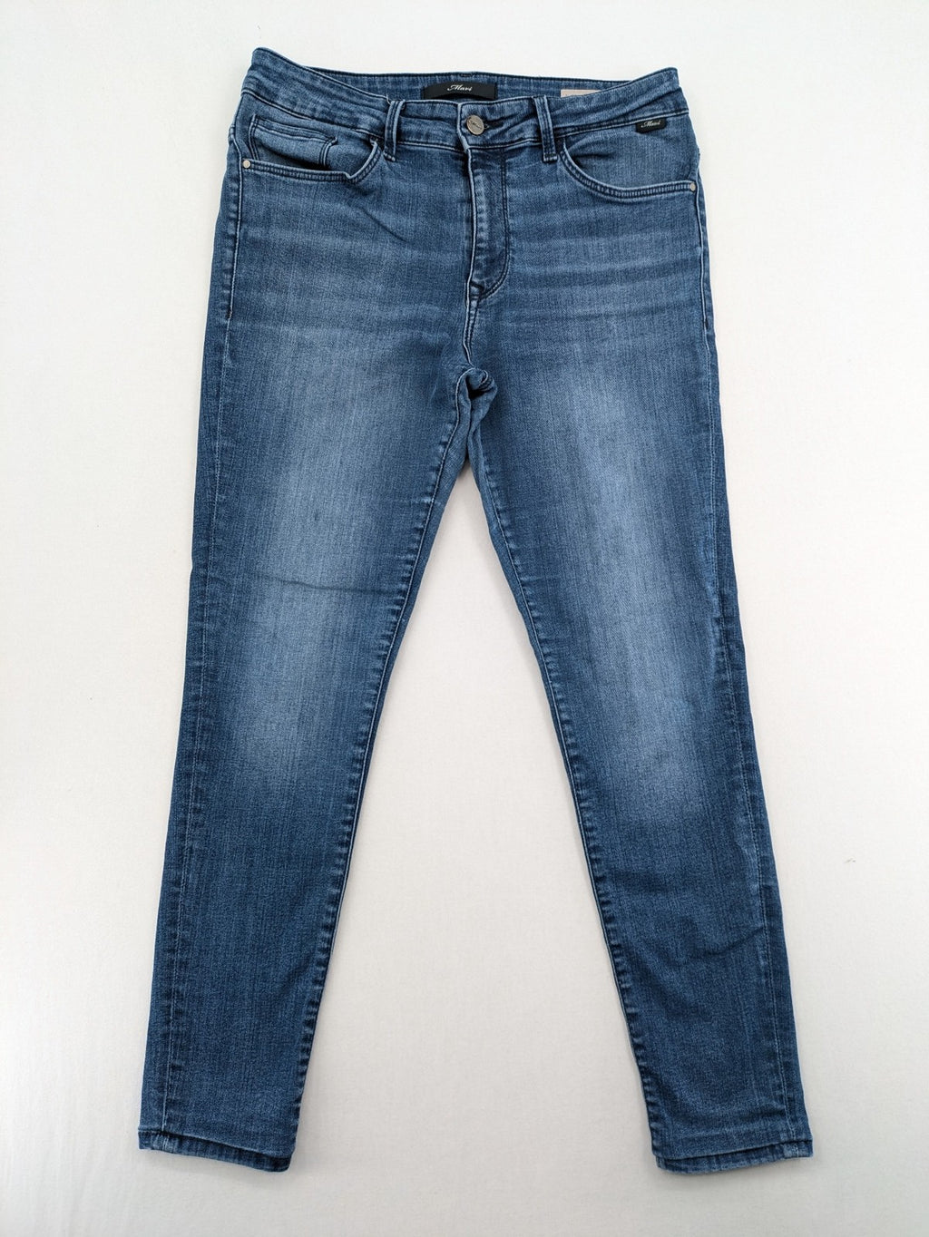 Mavi blue high rise super skinny jeans with medium wash and stretch denim material.