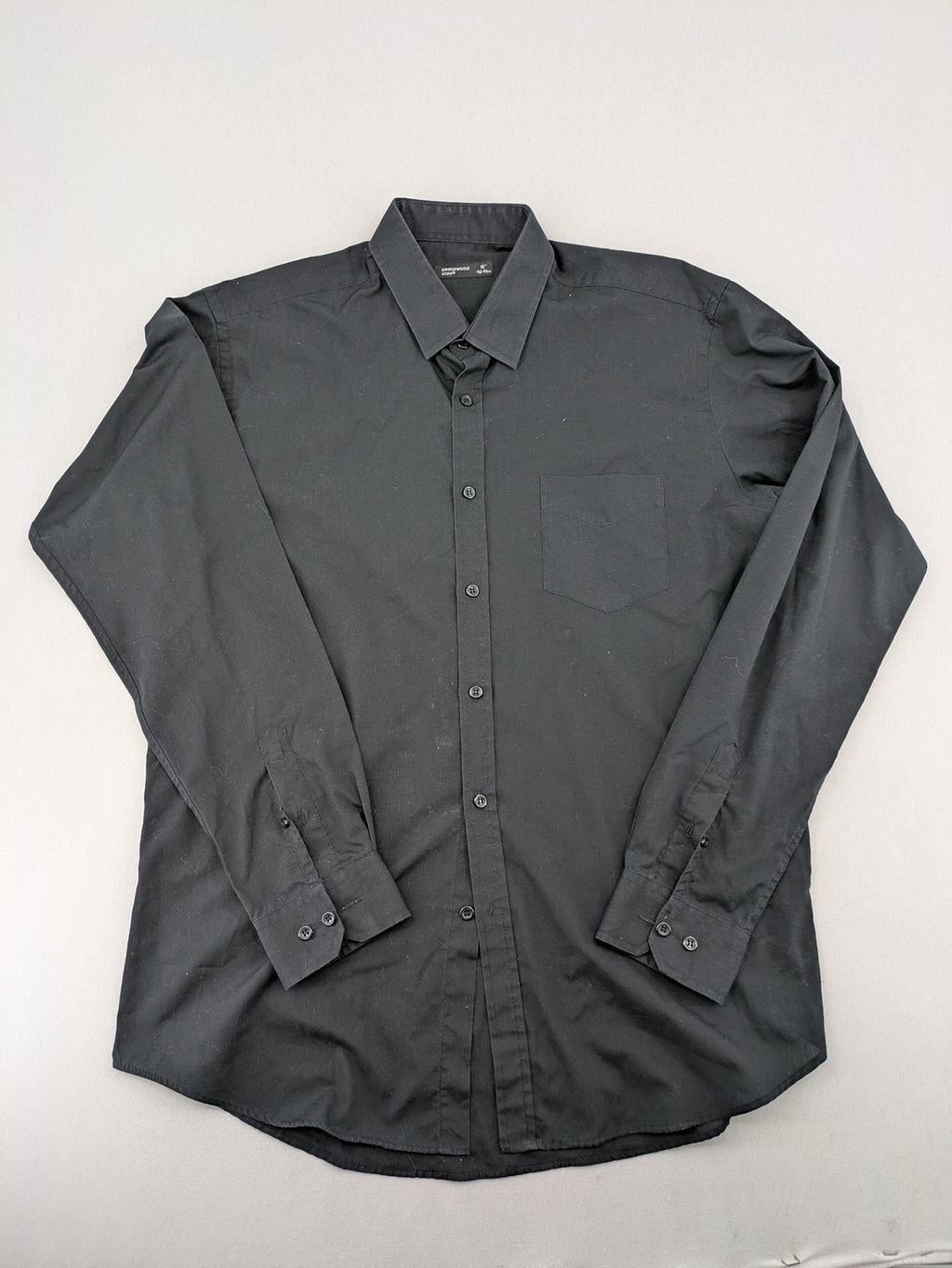 Cedarwood State black long sleeve shirt with classic collar and chest pocket.
