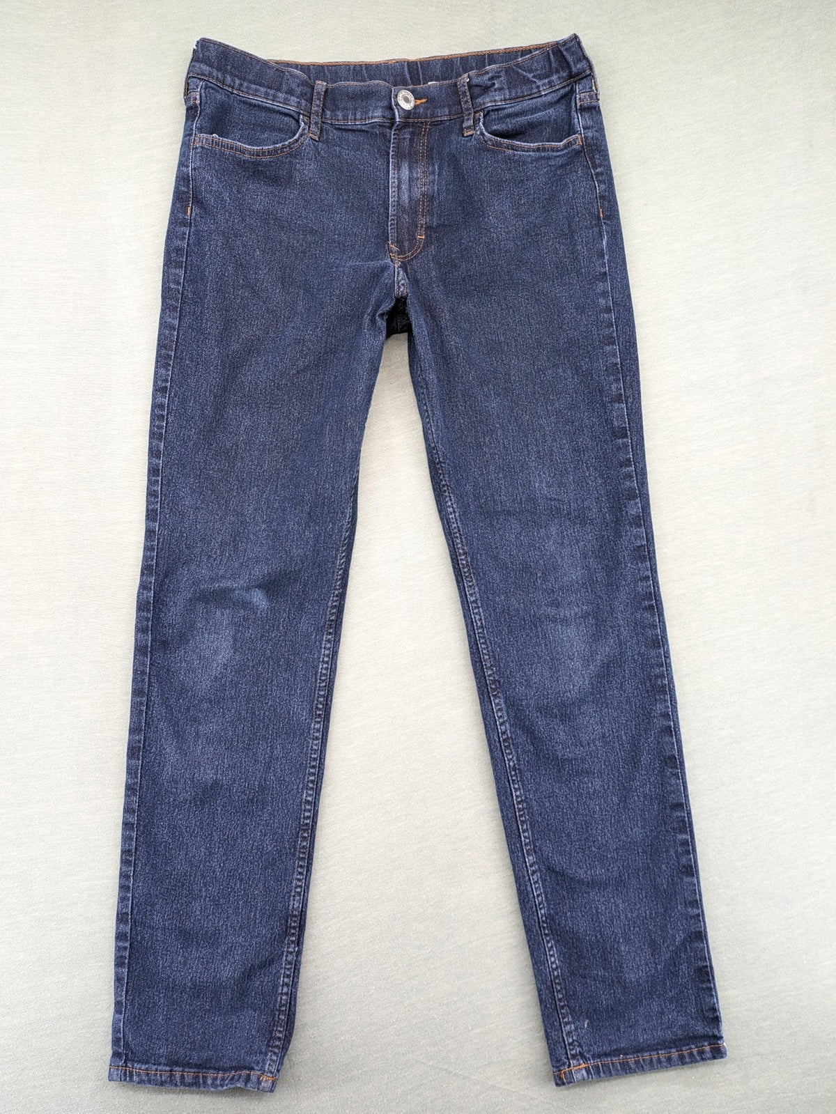 H&M blue straight jeans with adjustable waistband and classic 5-pocket design.