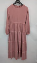 Moda pink bridal party dress with lace inserts, long sleeves, and tiered design.