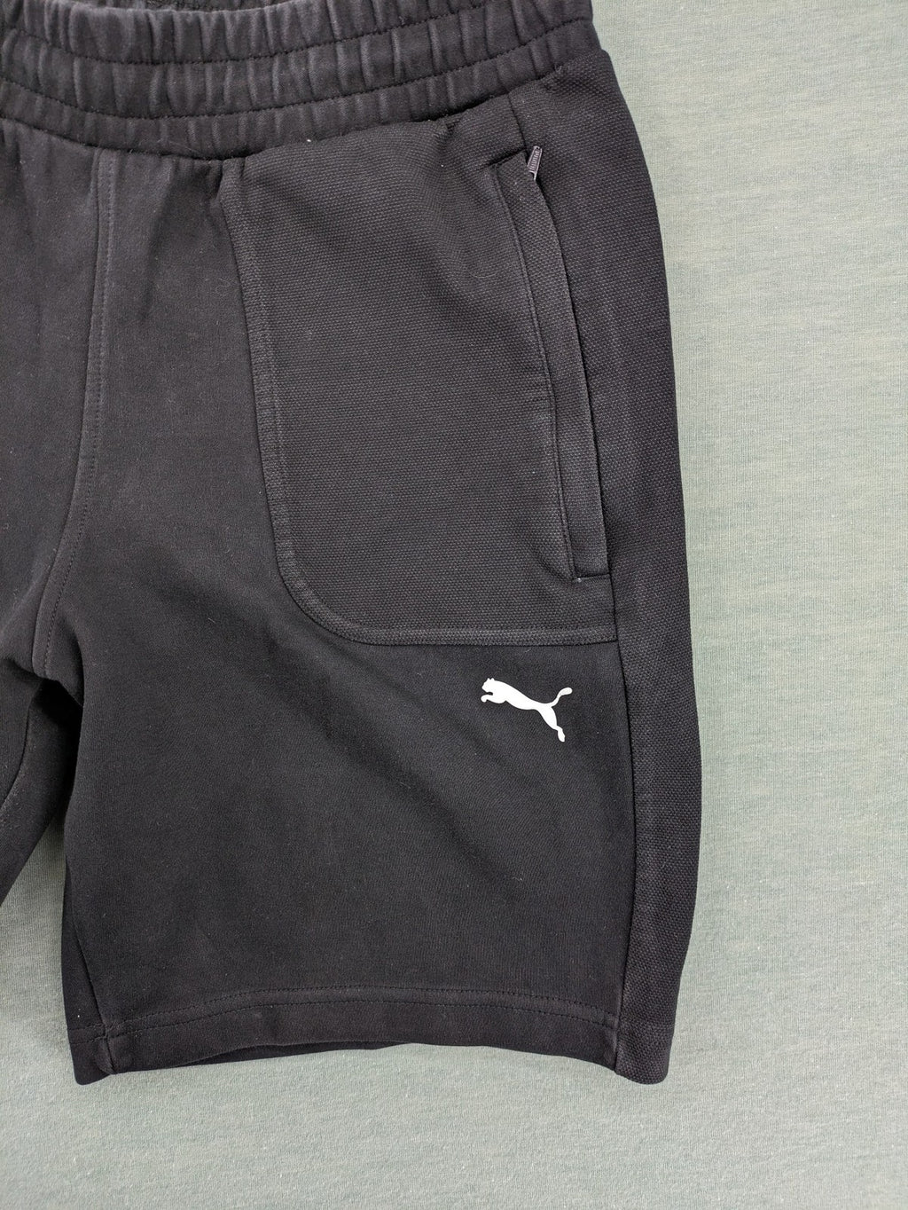Puma grey sweatshorts featuring Mercedes AMG Petronas logo and elastic waistband.