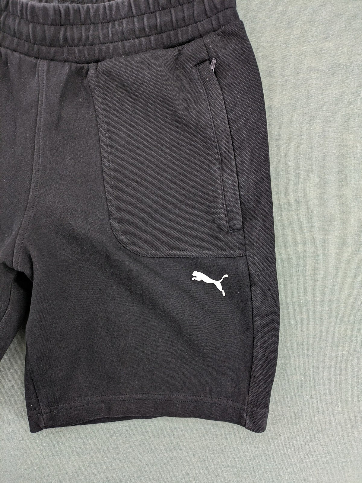 Puma grey sweatshorts featuring Mercedes AMG Petronas logo and elastic waistband.