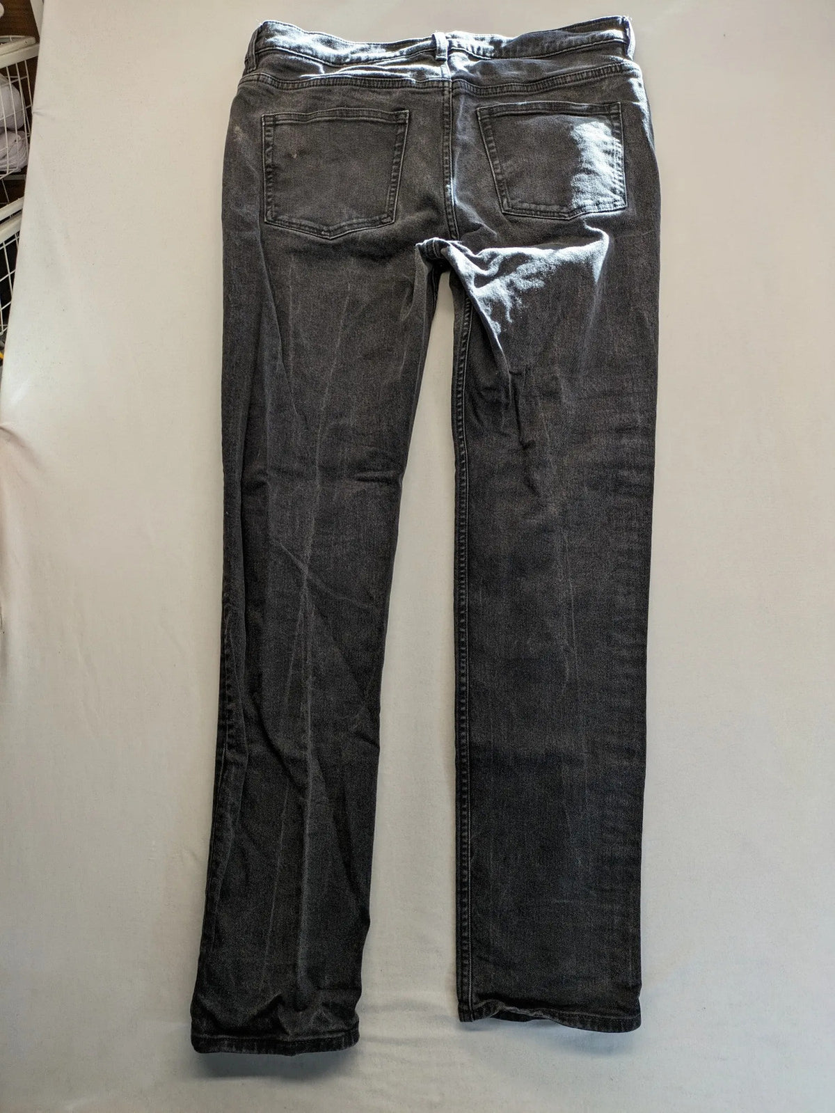 COS grey straight jeans with classic 5-pocket style and washed denim texture.