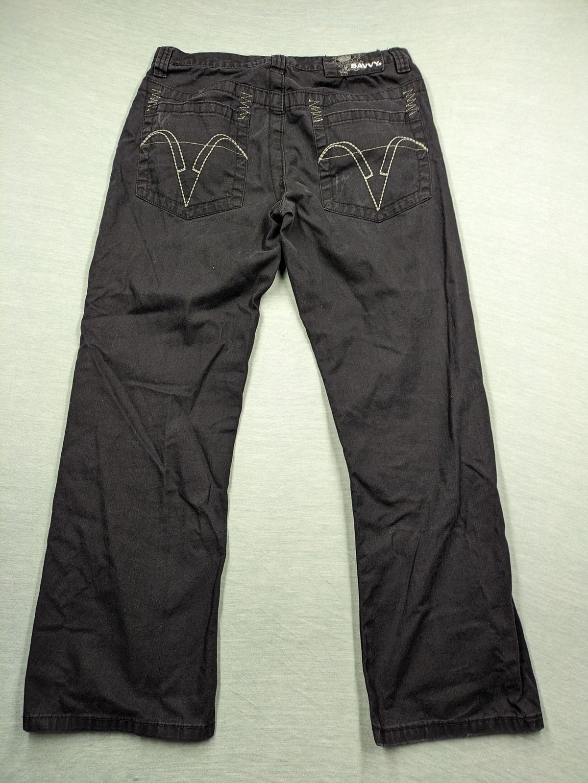 Savvy black pants straight fit with button fly, embroidered details and unique stitching.