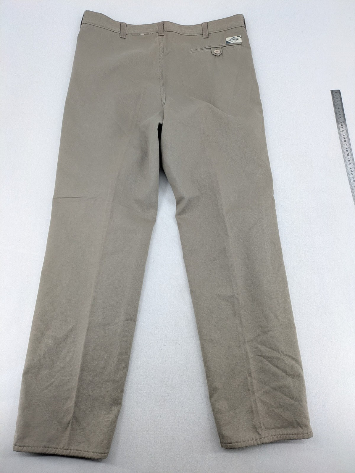 Pioneer beige chino trousers with pleats, straight leg, and buttoned back pocket.