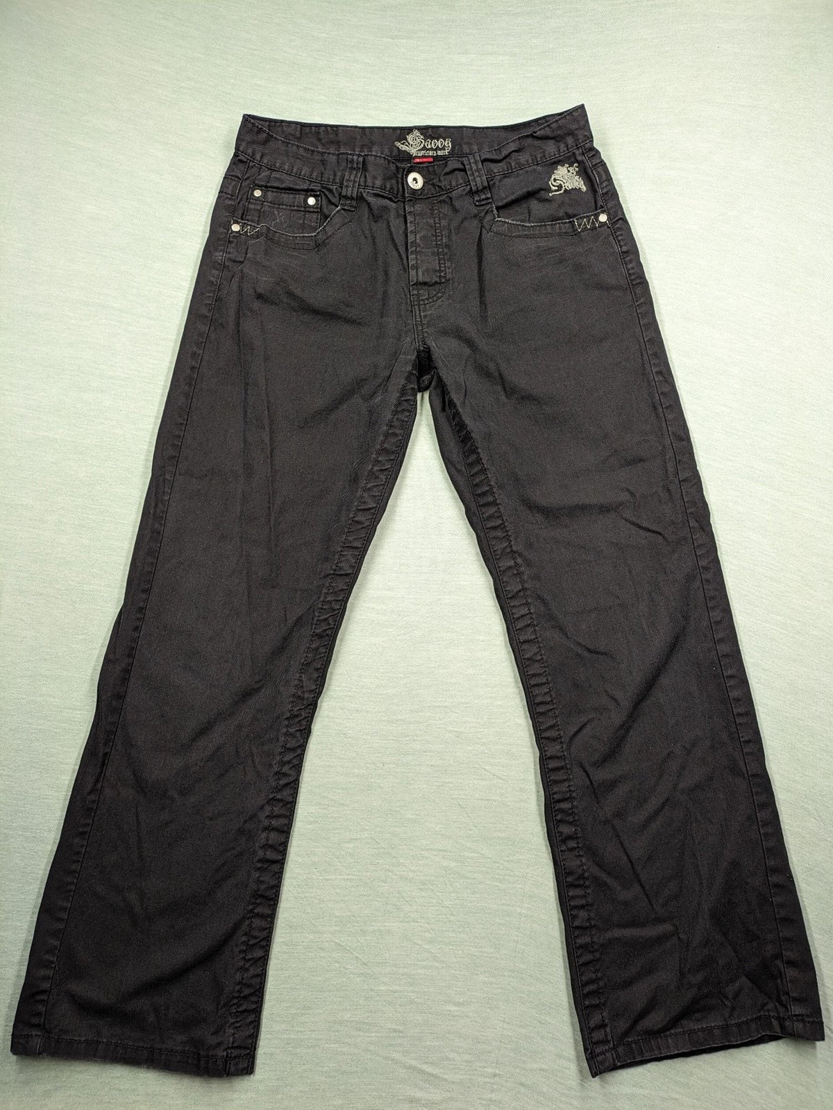 Savvy black pants straight fit with button fly, embroidered details and unique stitching.