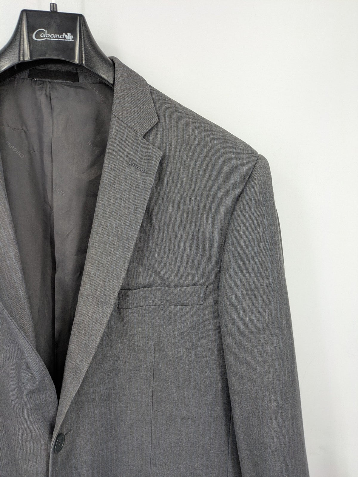 Alextrading grey jacket with subtle light blue pinstripe pattern and notch lapels.