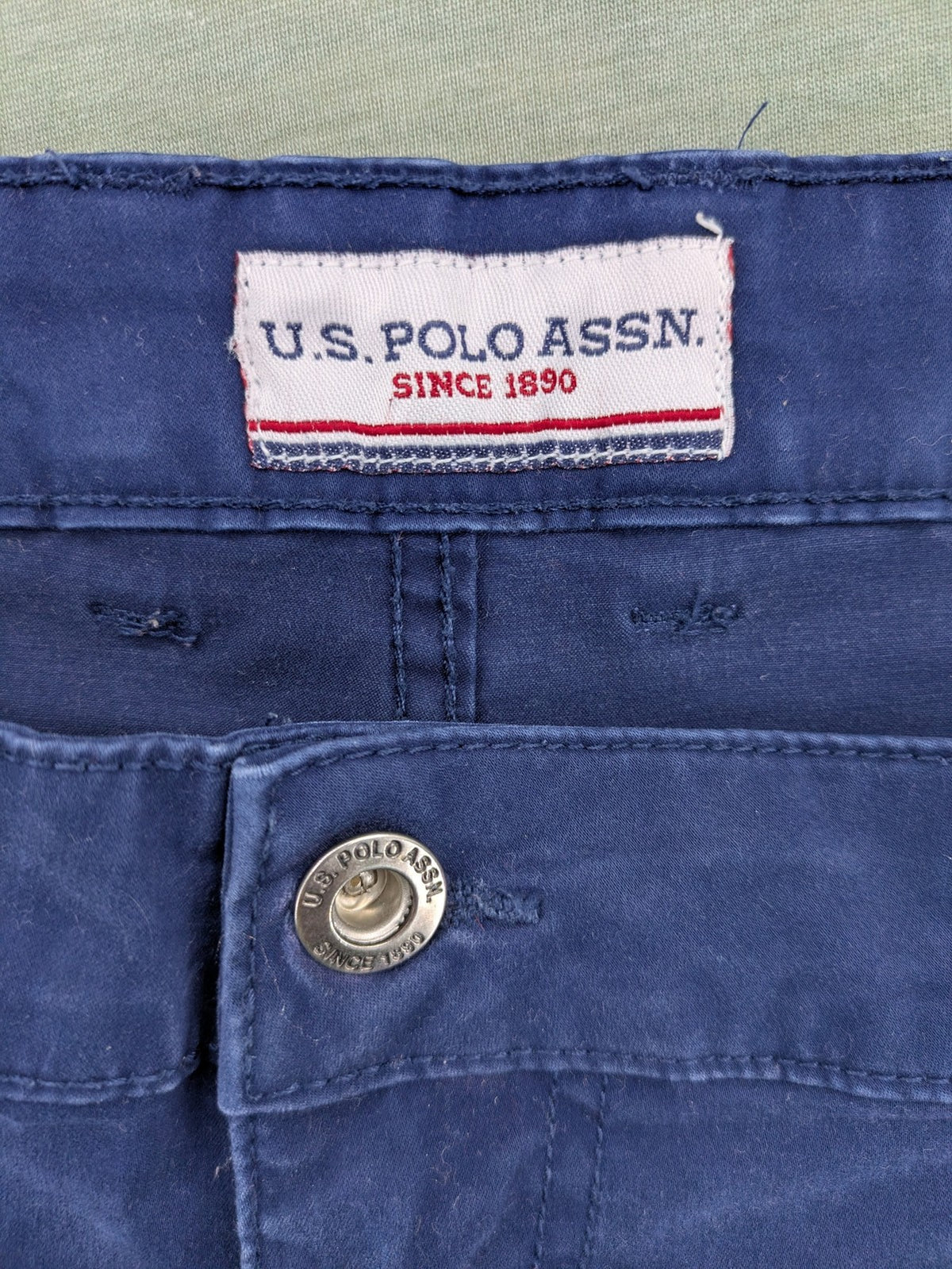 U.S. Polo Assn. navy chino pants classic 5-pocket design with subtle logo stitching