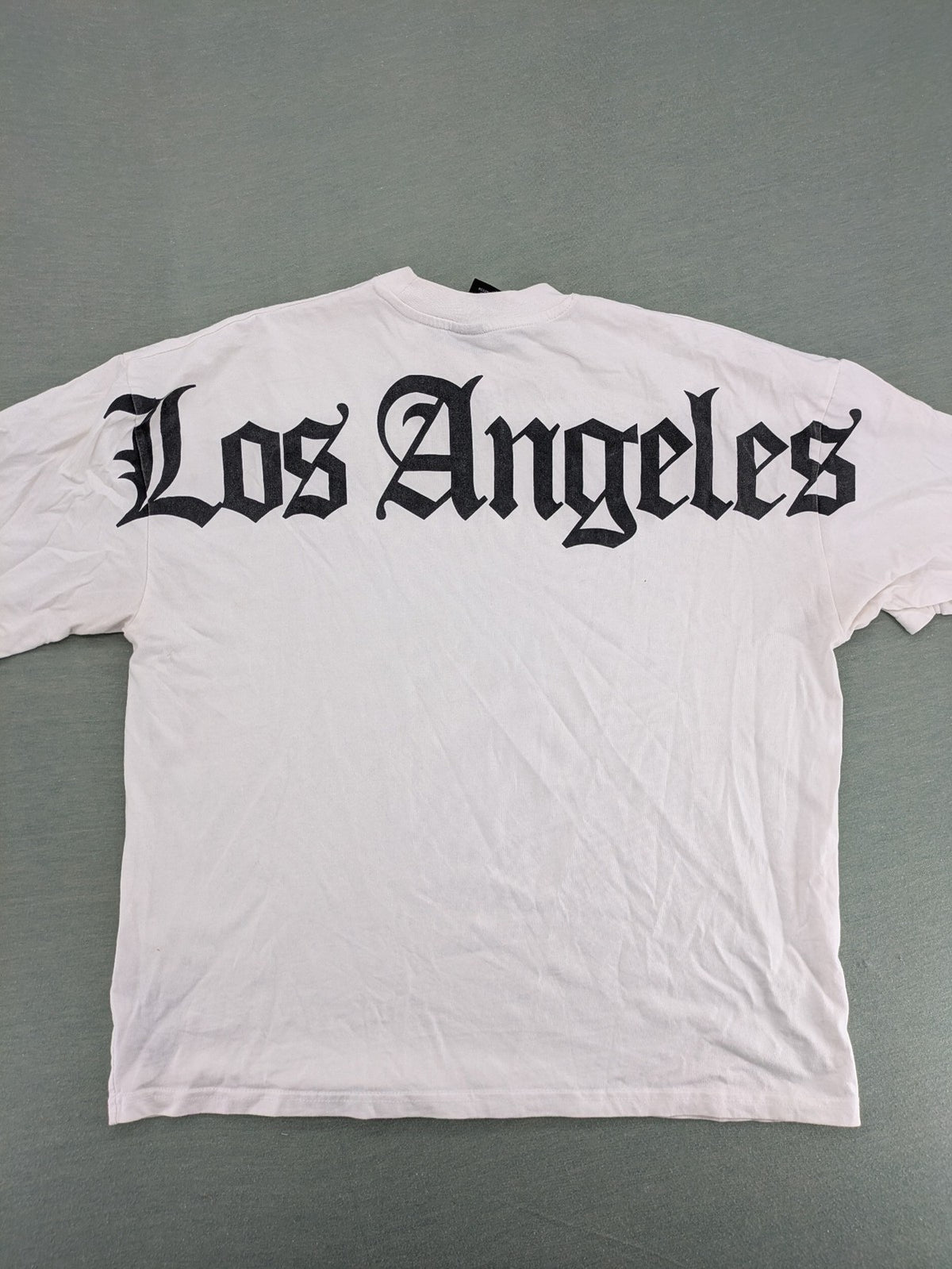 Black Squad black oversized t-shirt with white "Los Angeles" backprint and cotton material.