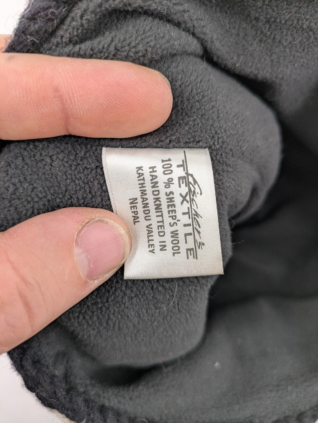 Fischers Textil multi beanie hand-knitted wool with fleece lining and floral appliqué.
