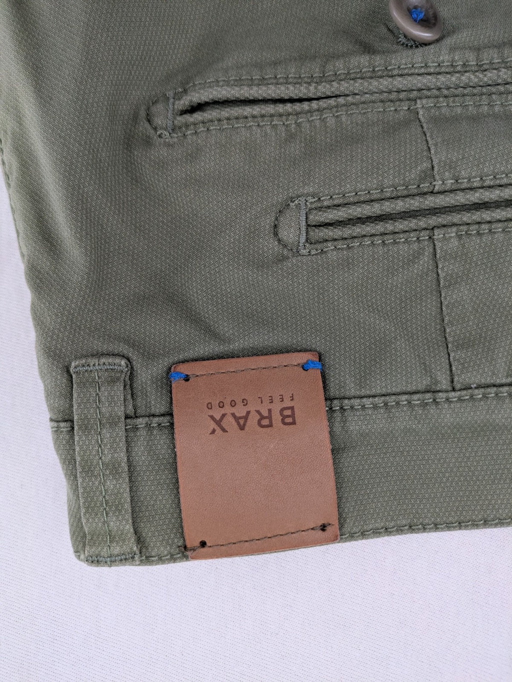 BRAX green chino pants flat-front design with zipper and buttoned back pockets.