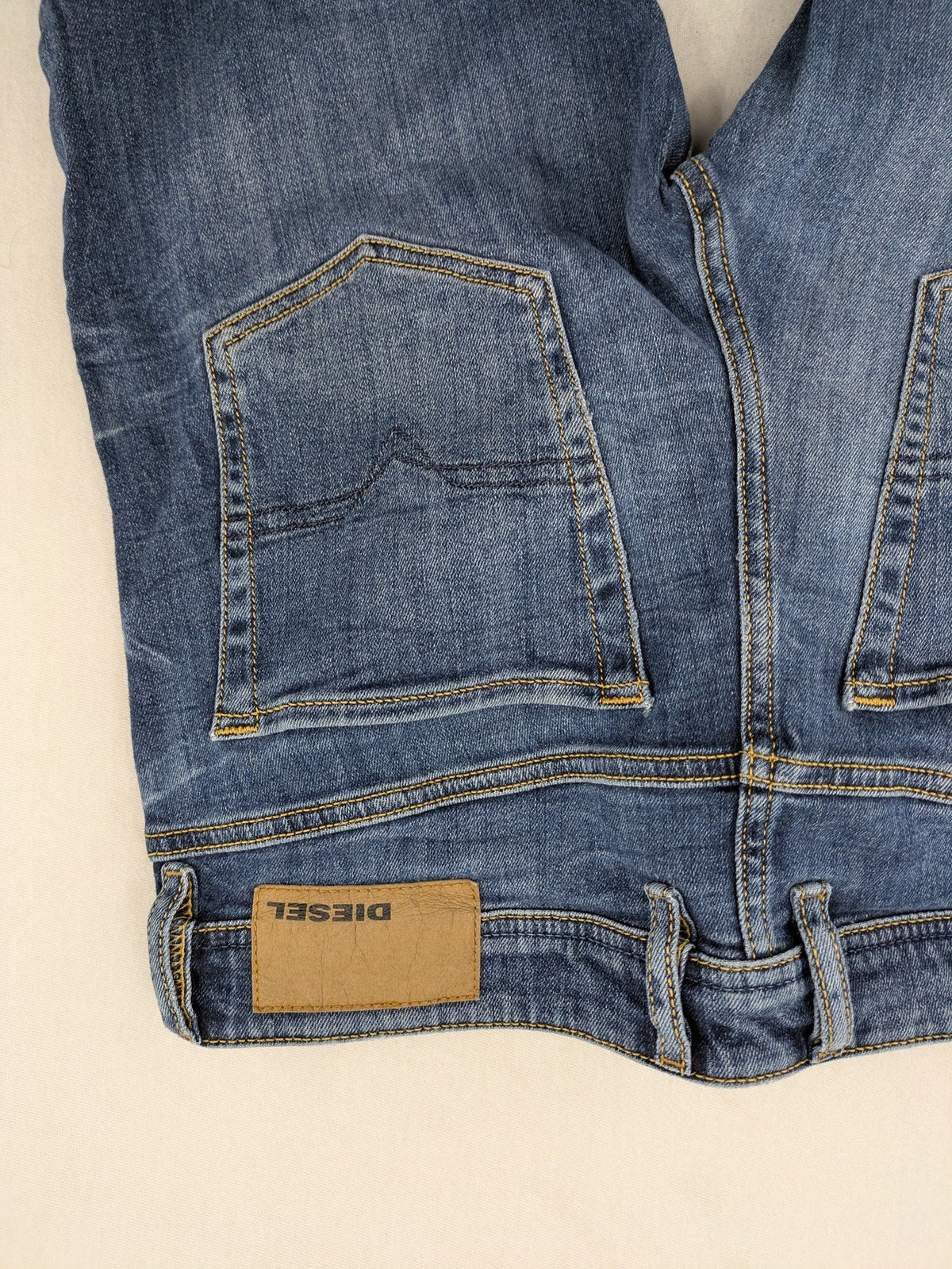 Diesel blue slim skinny jeans with logo patch and stretch denim material.