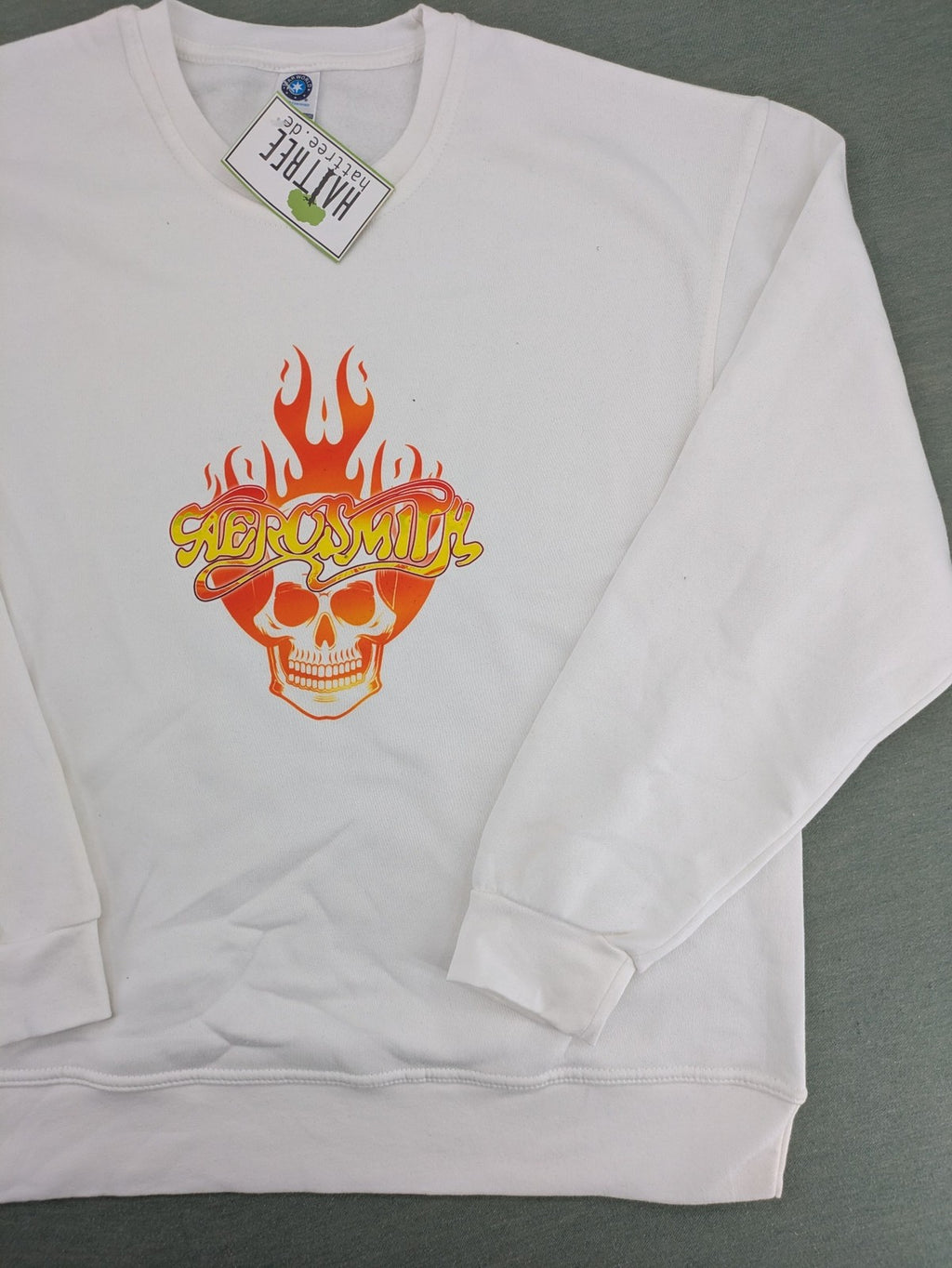 Aerosmith white sweatshirt with bold front graphic, logo, and flaming skull design.