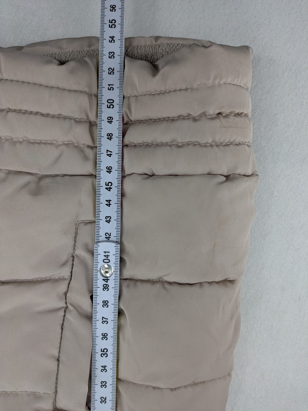 Brit Island beige puffer coat with fleece lining and faux fur hood detail.