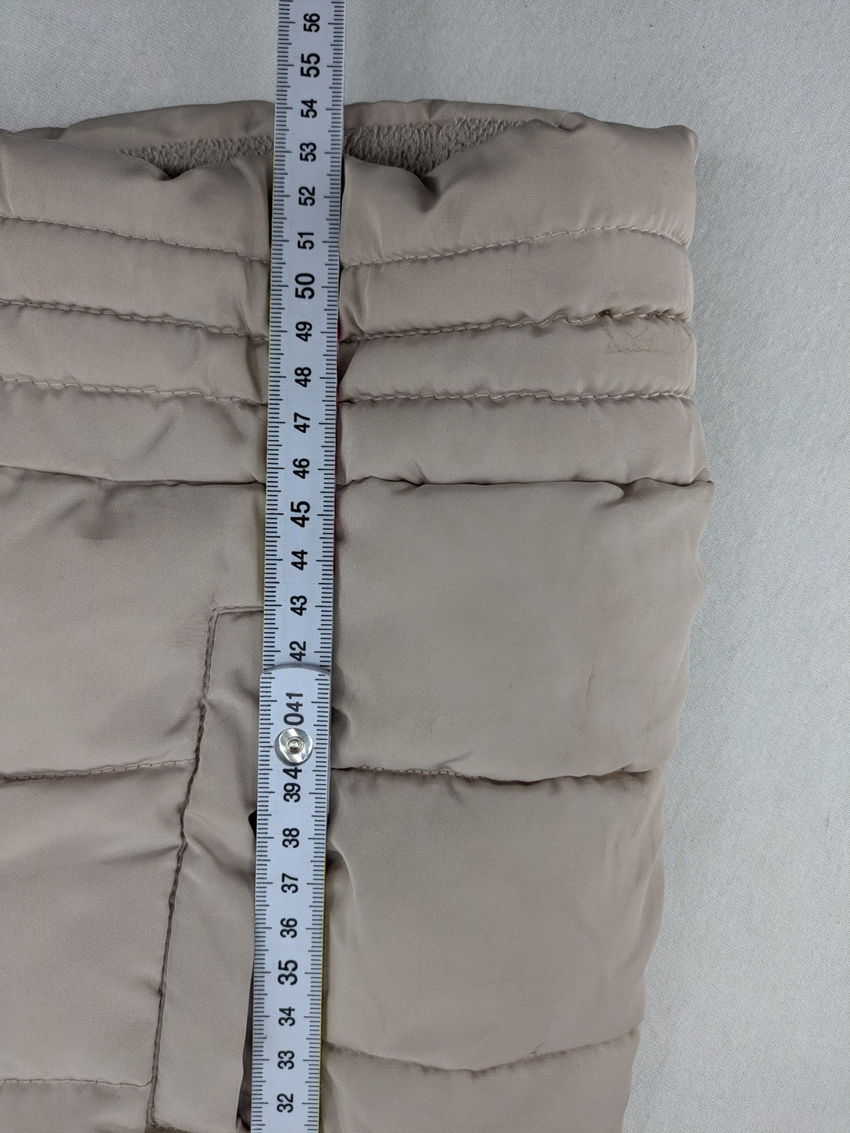 Brit Island beige puffer coat with fleece lining and faux fur hood detail.