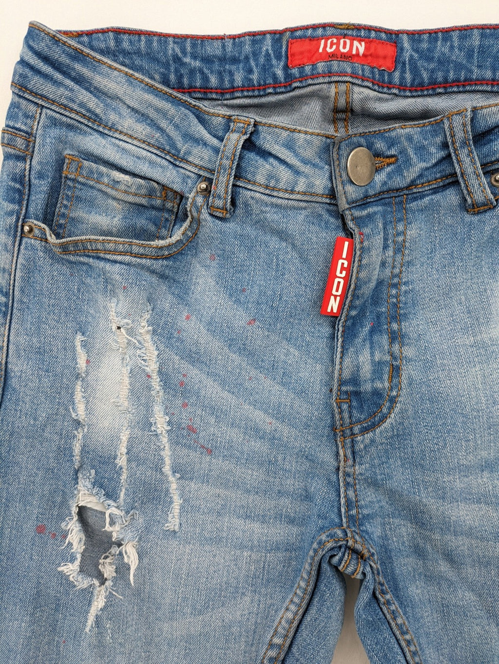 Milano straight jeans light blue distressed with red splatter and extra slim fit.