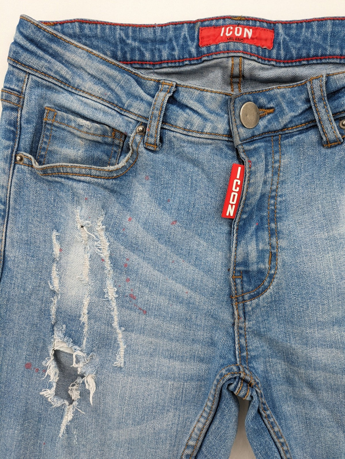 Milano straight jeans light blue distressed with red splatter and extra slim fit.