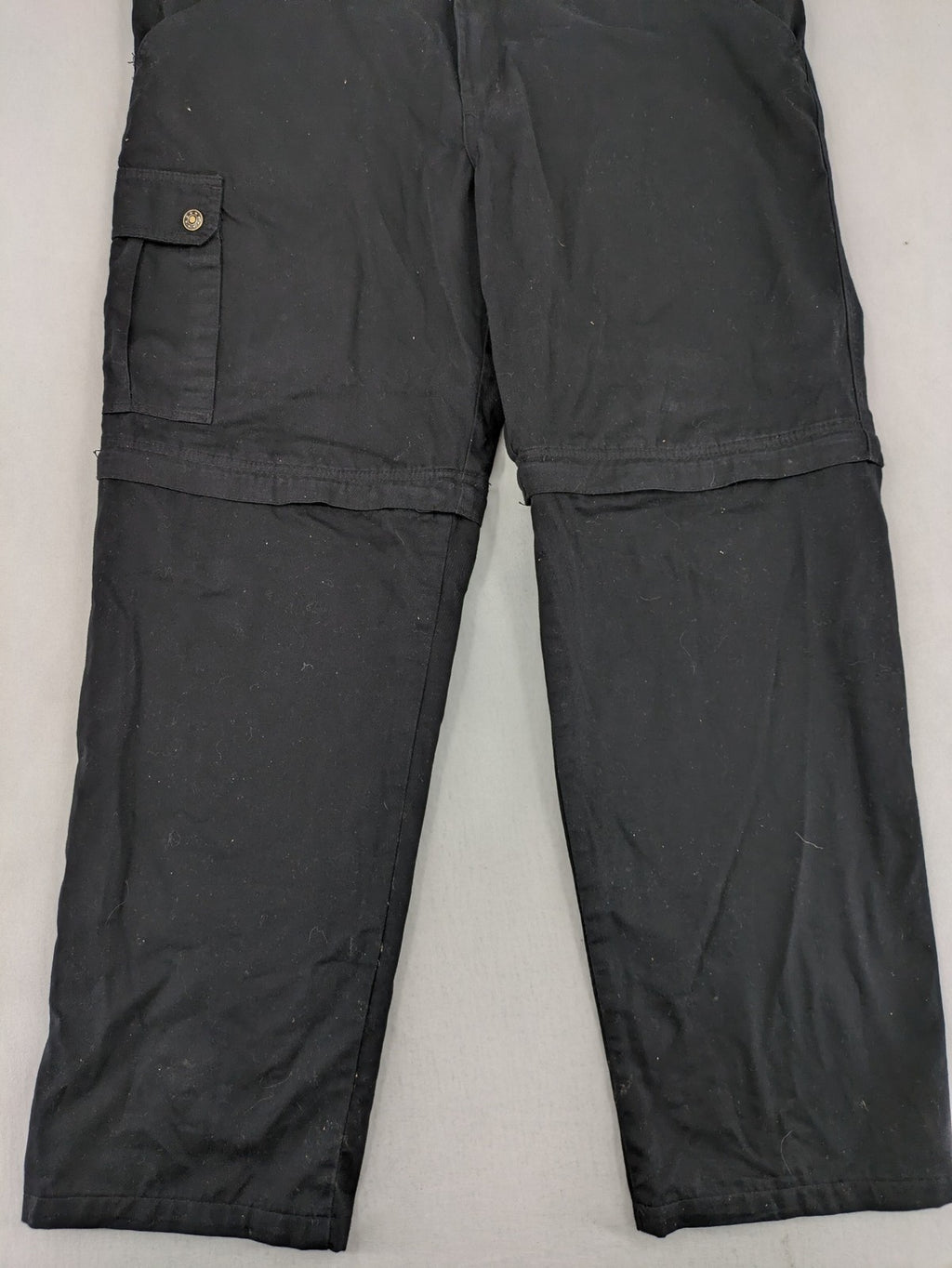 Travel Master black hunting and tactical pants, zip-off design, 100% cotton, multiple pockets.