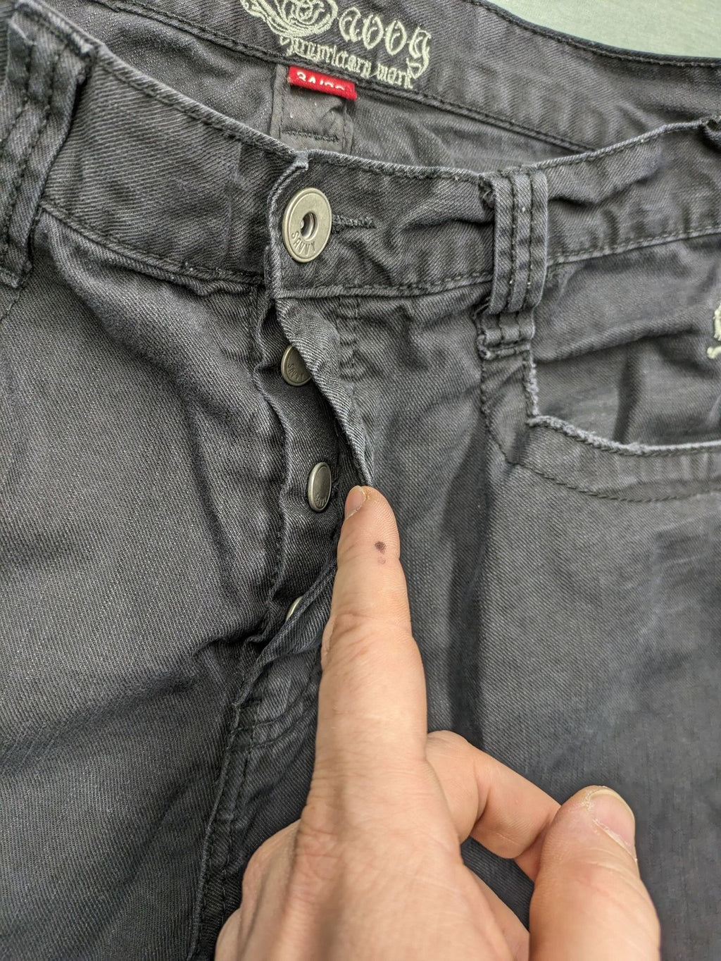 Savvy black pants straight fit with button fly, embroidered details and unique stitching.