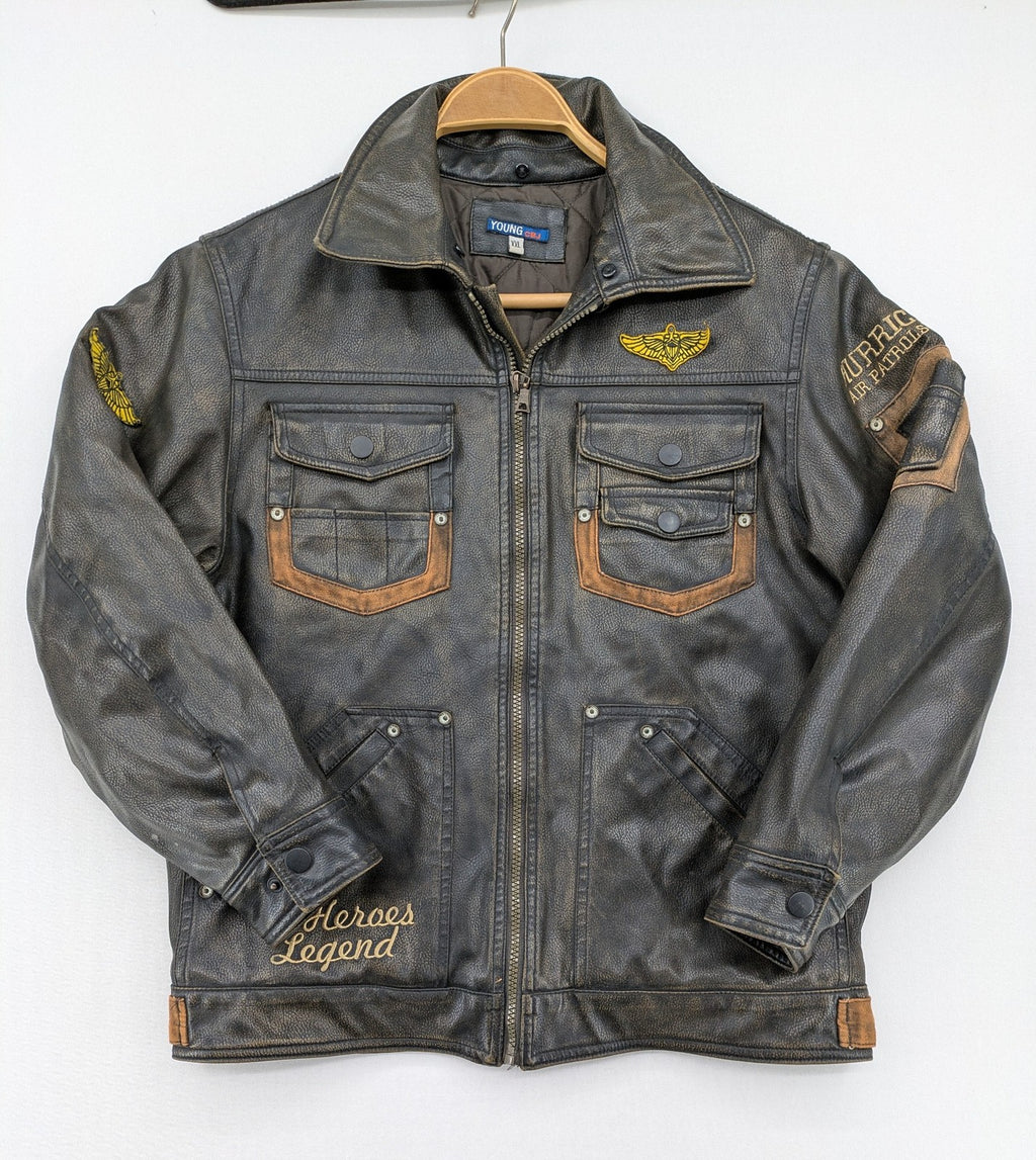Junge brown bomber jacket with vintage patches and embroidered details in faux leather.