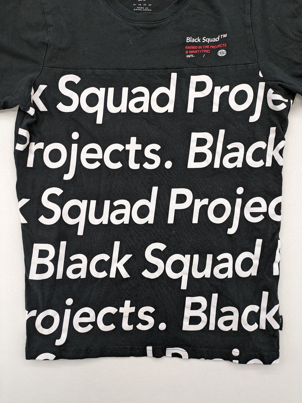 Black Squad black t-shirt all-over graphic print with logo patch on sleeve.