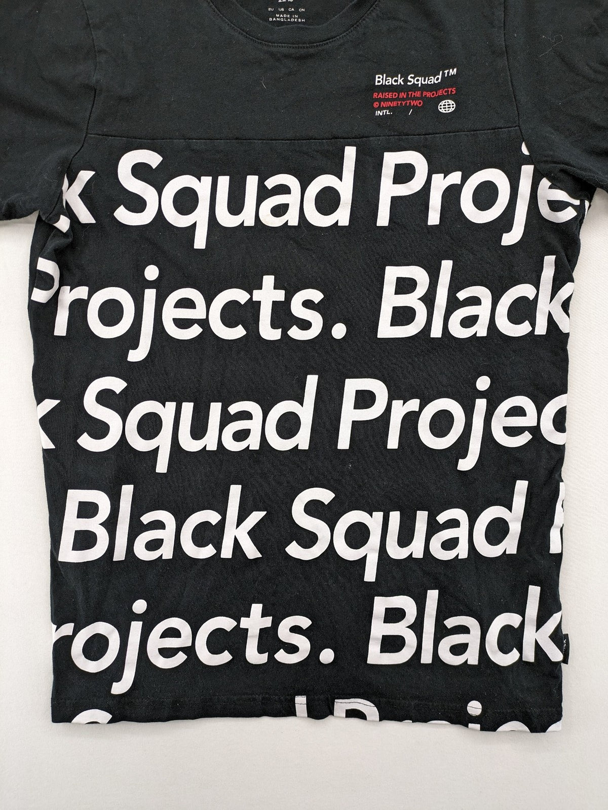 Black Squad black t-shirt all-over graphic print with logo patch on sleeve.