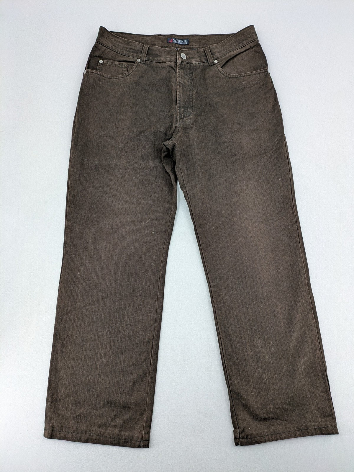 Authentic Clothing Company brown straight jeans with subtle stripe pattern and brand patch.