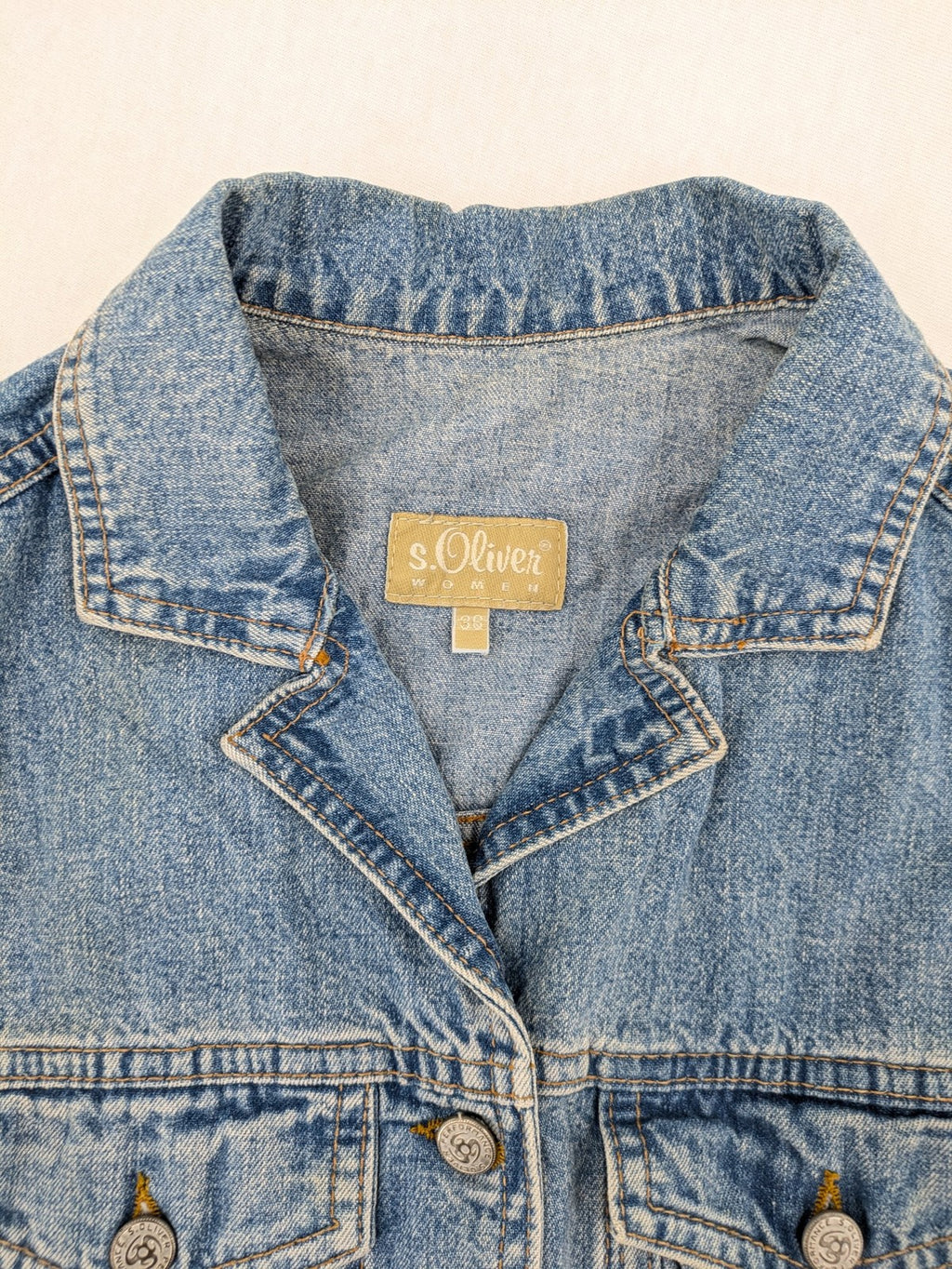s.Oliver blue denim vest with button closure, pointed collar, and breast pockets.