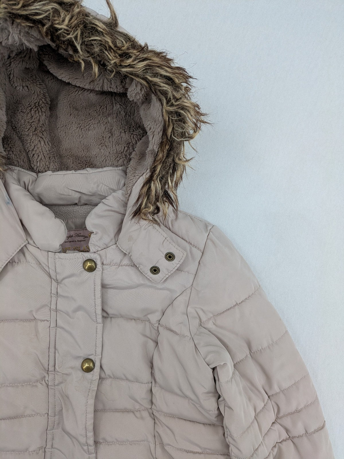 Brit Island beige puffer coat with fleece lining and faux fur hood detail.
