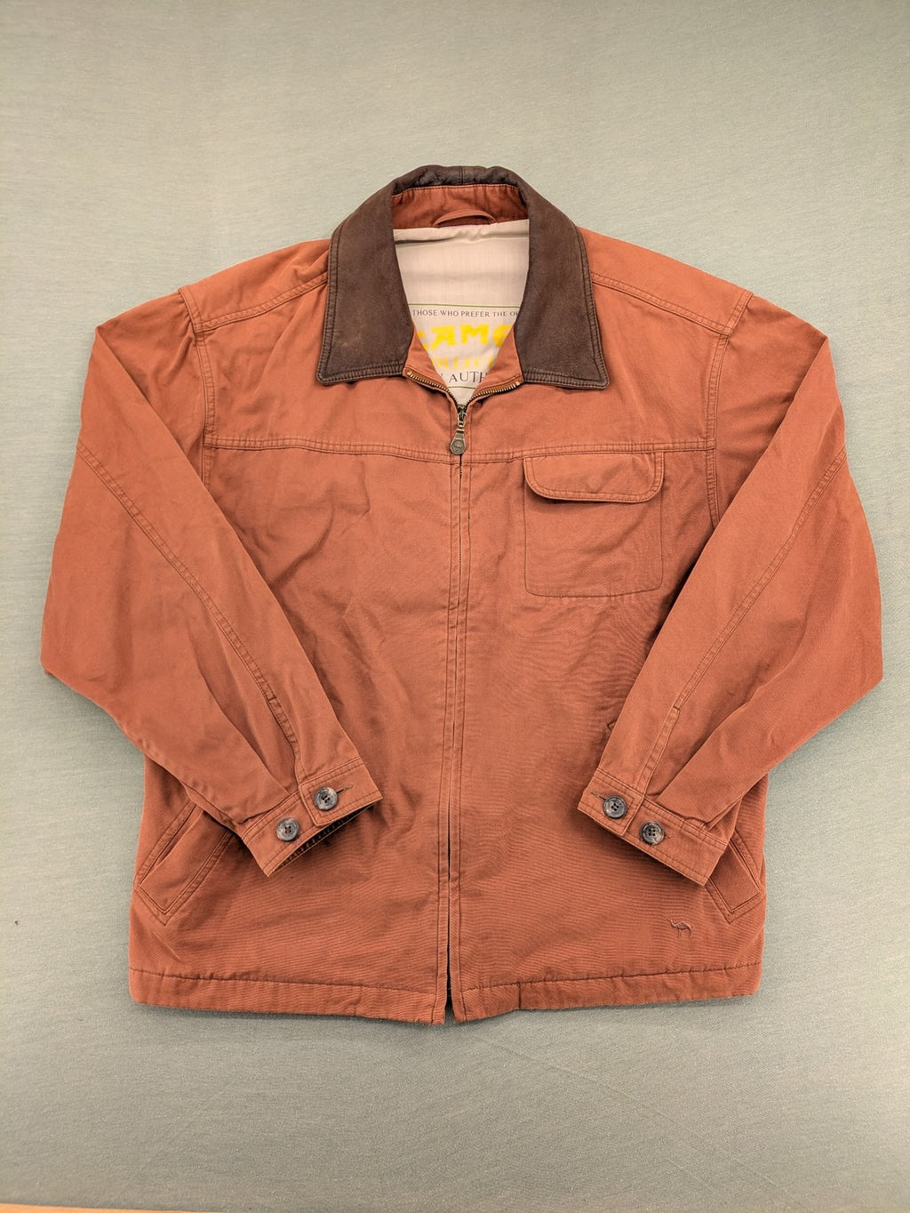 Camel Collection brown jacket with orange contrast collar and embroidered logo.
