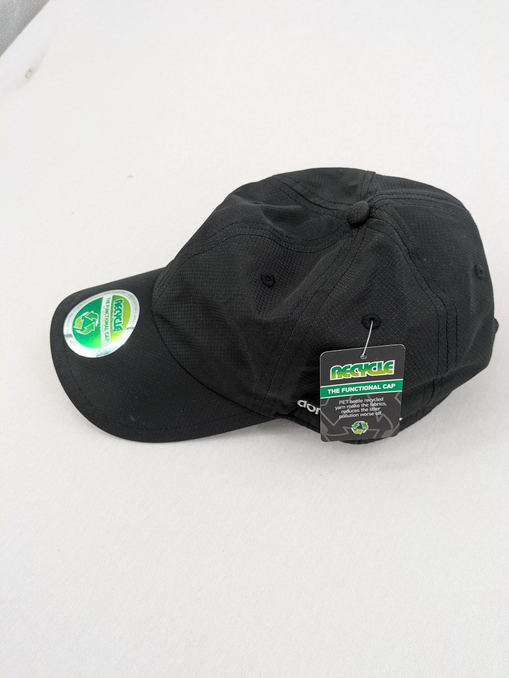 Funktional grey baseball cap with embroidered Dormakaba logo and modern ripstop texture.