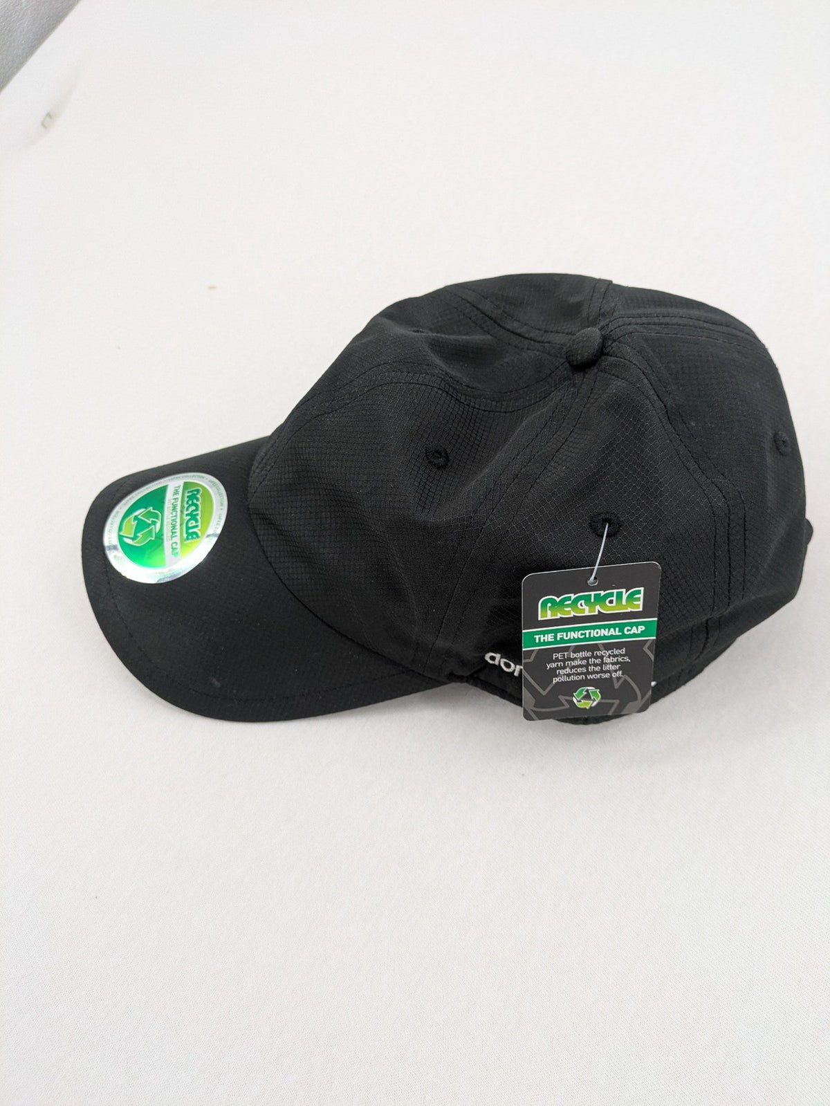 Funktional grey baseball cap with embroidered Dormakaba logo and modern ripstop texture.