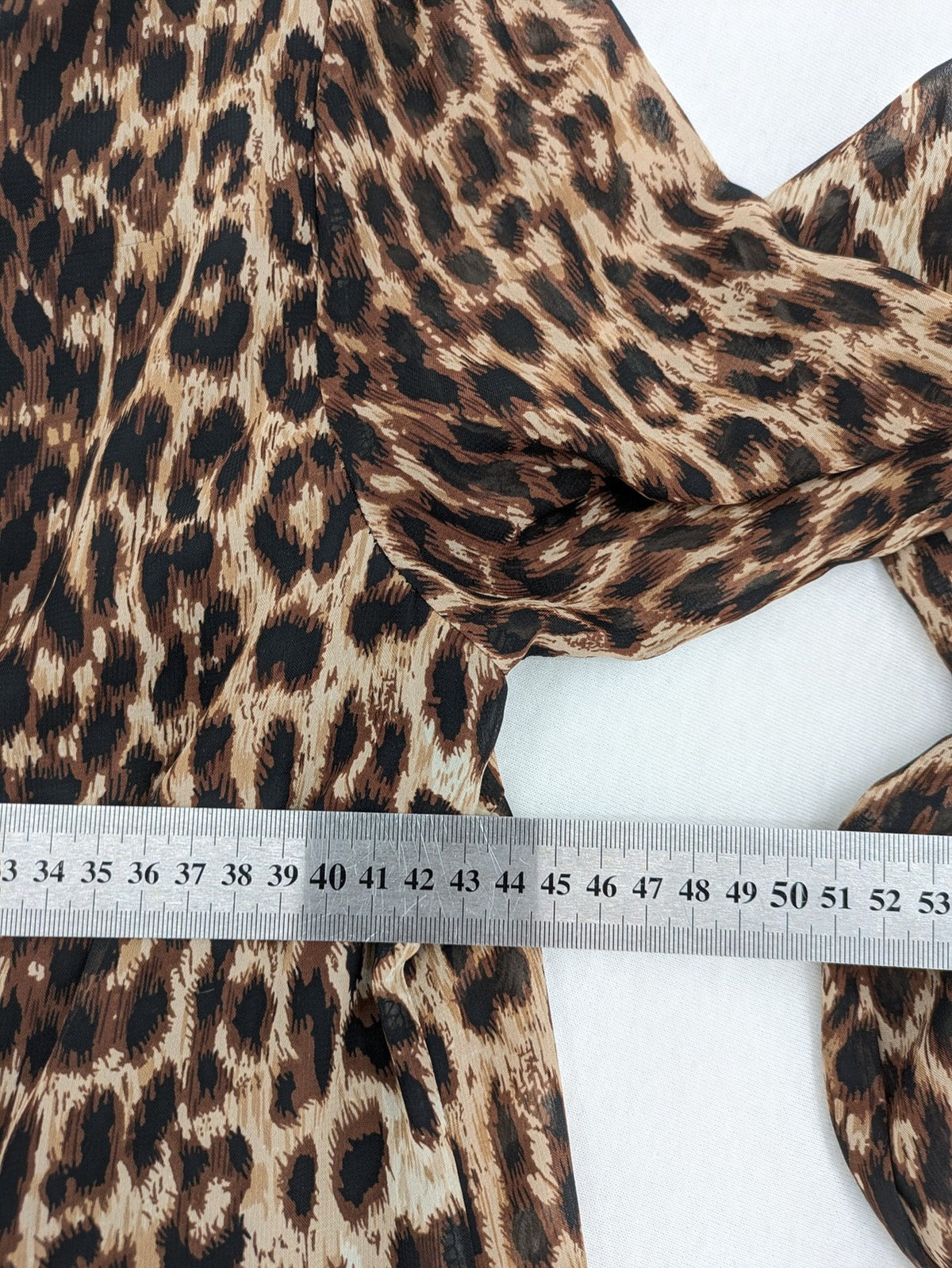 Atmosphere beige leopard print dress with sheer chiffon sleeves and buttoned cuffs.