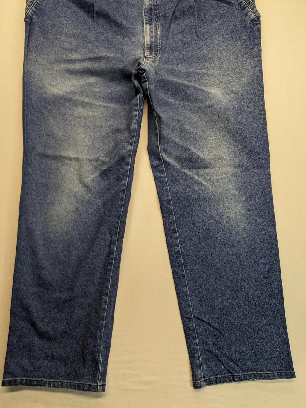 REI blue straight jeans with front pleats, zip fly, and buttoned back pockets.