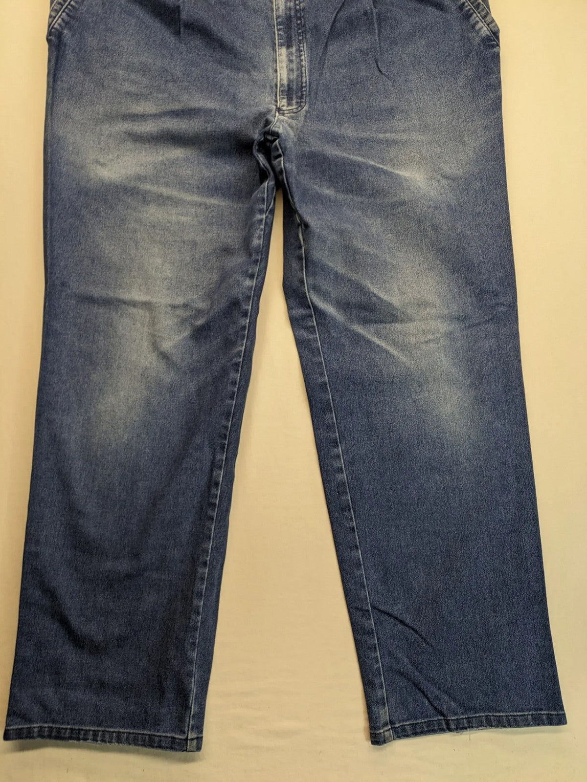 REI blue straight jeans with front pleats, zip fly, and buttoned back pockets.