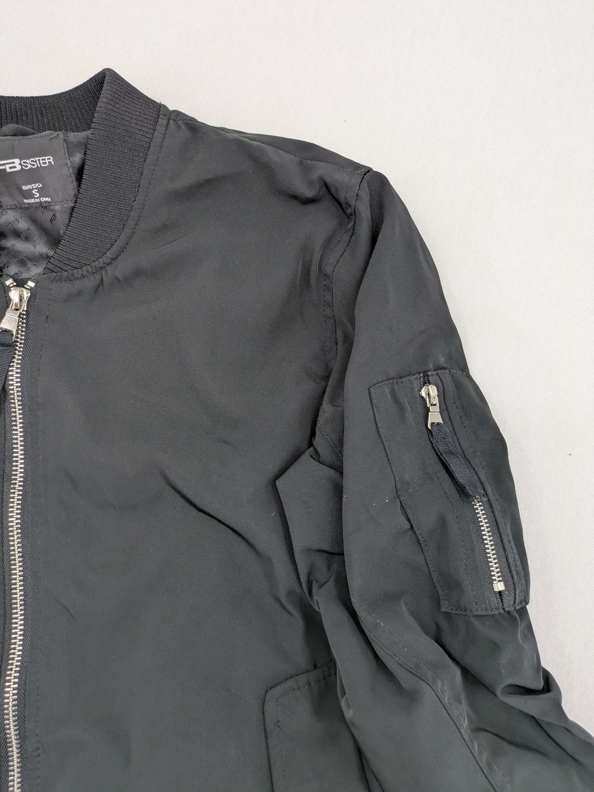 FB Sister grey bomber jacket with full zip, ribbed cuffs, and smooth polyester material.