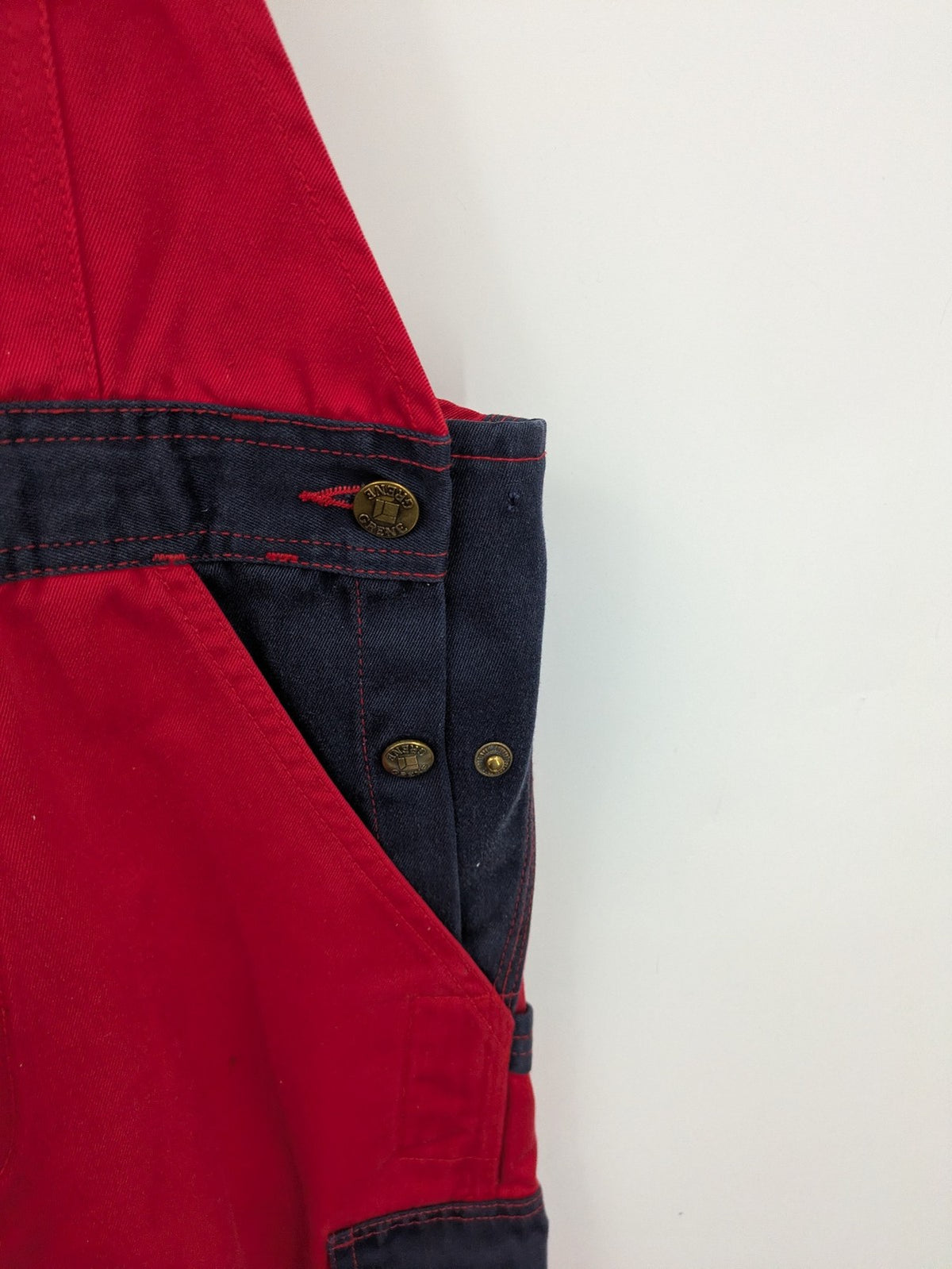 Grene navy red overall with adjustable straps, multiple pockets, and durable material.