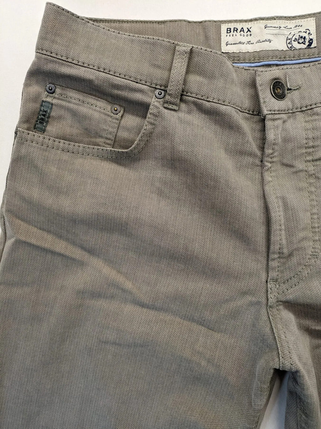 BRAX grey straight jeans 5-pocket design with zipper fly and soft fabric.