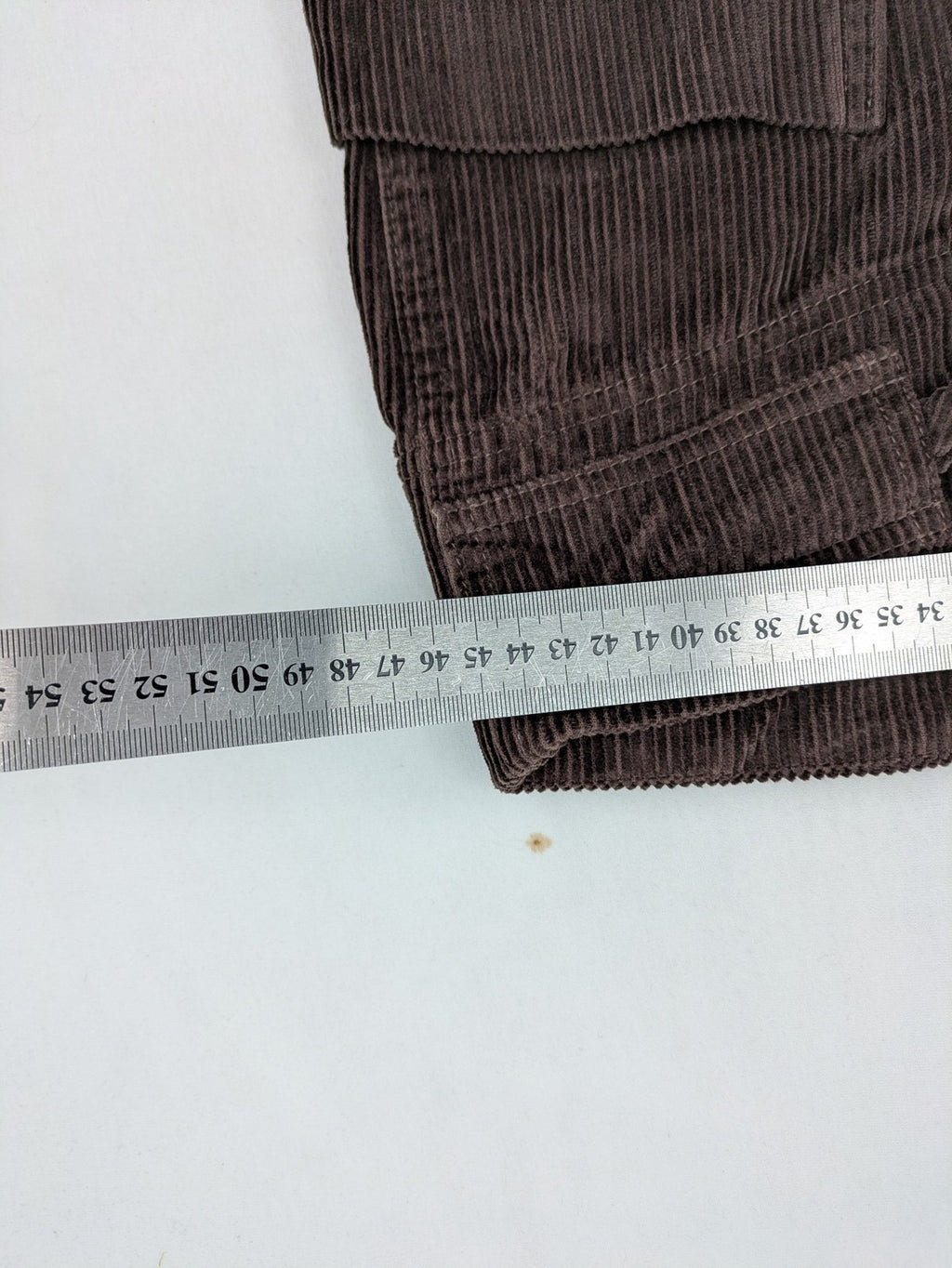 Alma & Lovis brown cord pants with elastic waistband, drawstring, and front patch pockets.