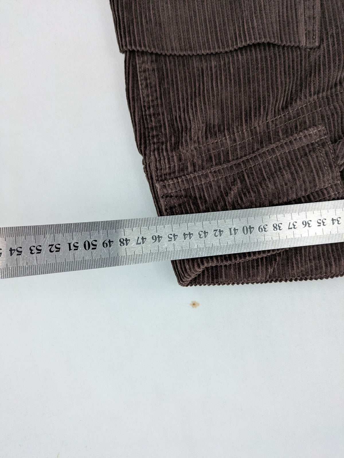 Alma & Lovis brown cord pants with elastic waistband, drawstring, and front patch pockets.