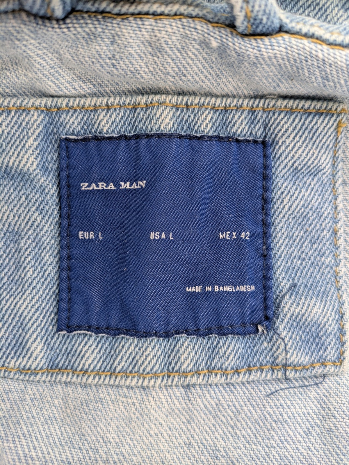 Zara Man blue denim jacket distressed with button closure and chest pockets.