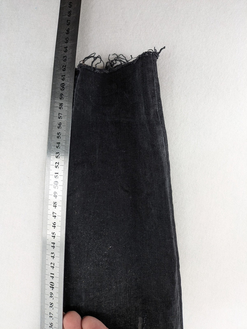Zara Woman black skinny jeans with distressed details, silver studs, and frayed hem.