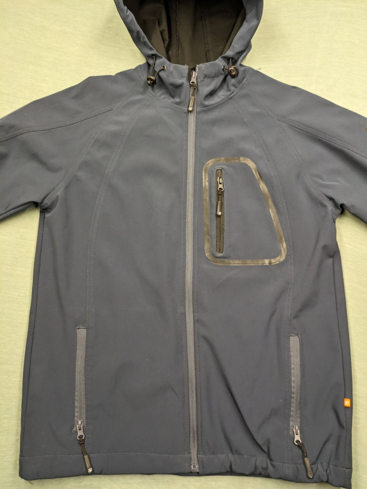 Life Line grey softshell jacket with adjustable hood and durable wind-resistant material.