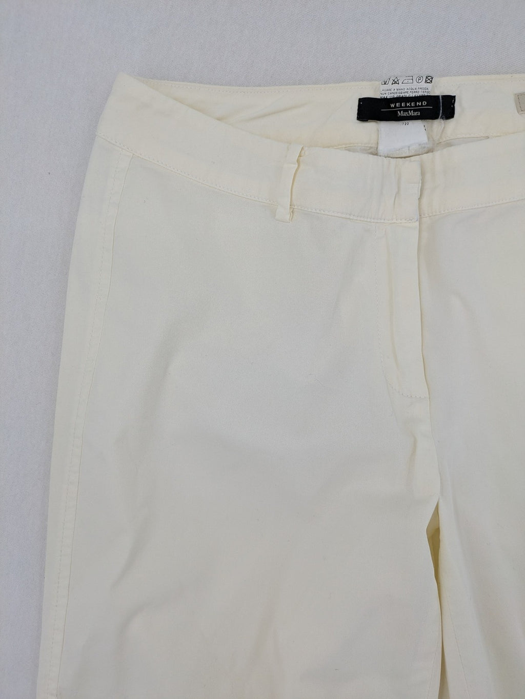 MaxMara cream cropped chino pants with zipper closure, belt loops, and back pockets.