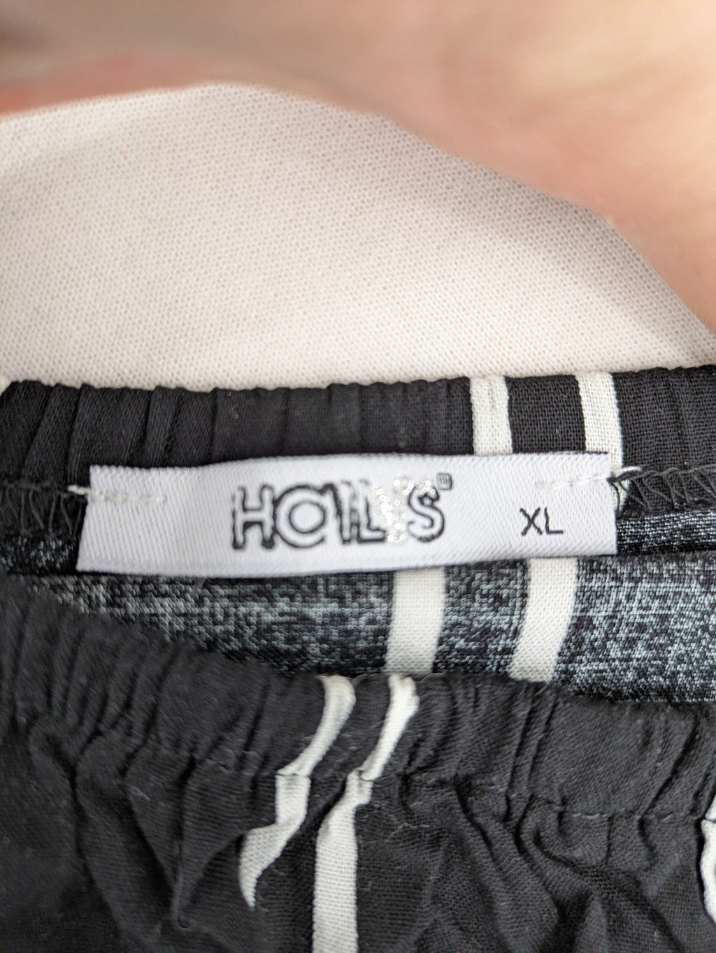 Hailys black and white striped crop top with front tie and off-shoulder design.