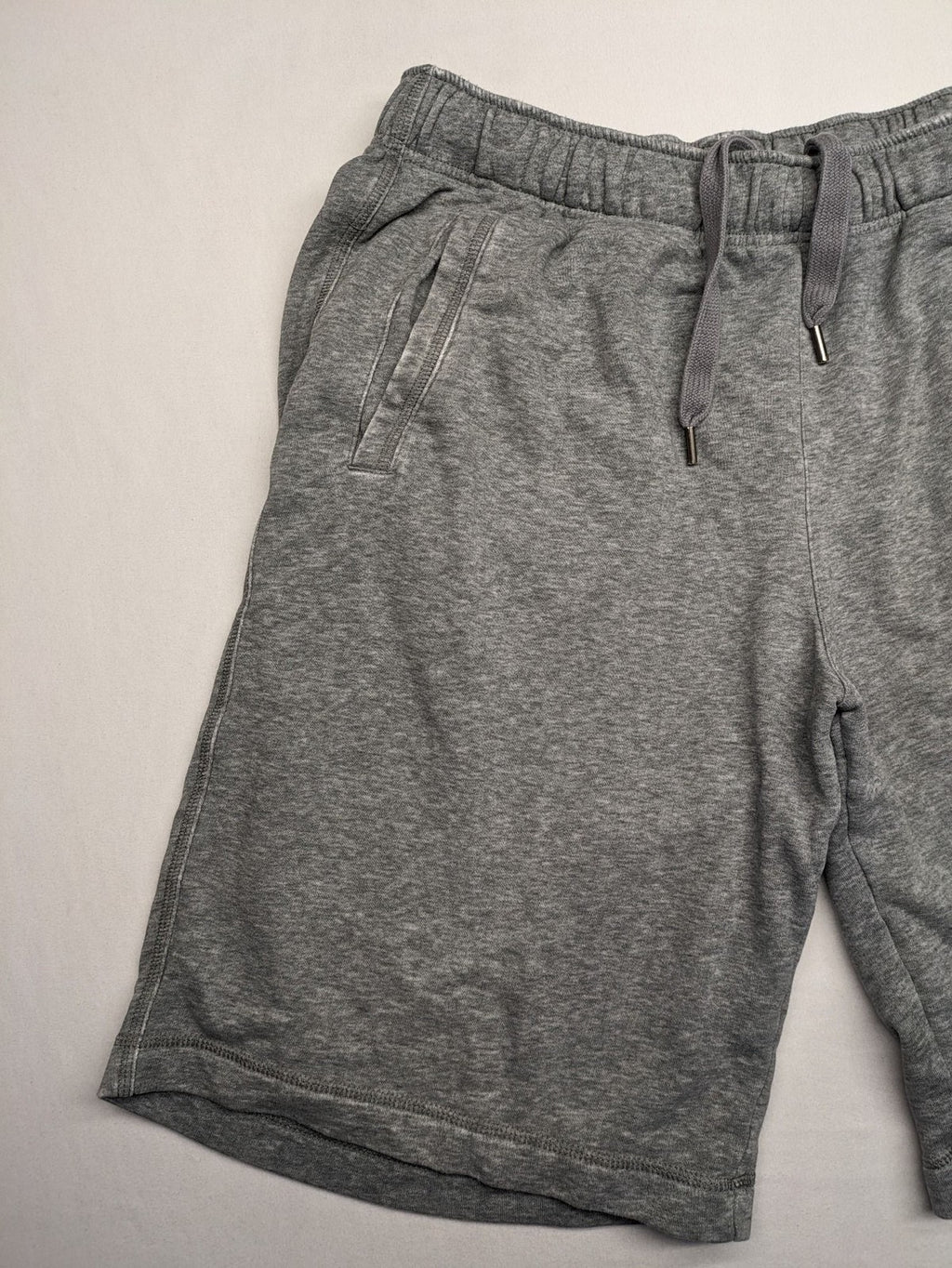 Puma grey sweat shorts with embroidered logo, made from cotton-polyester blend.