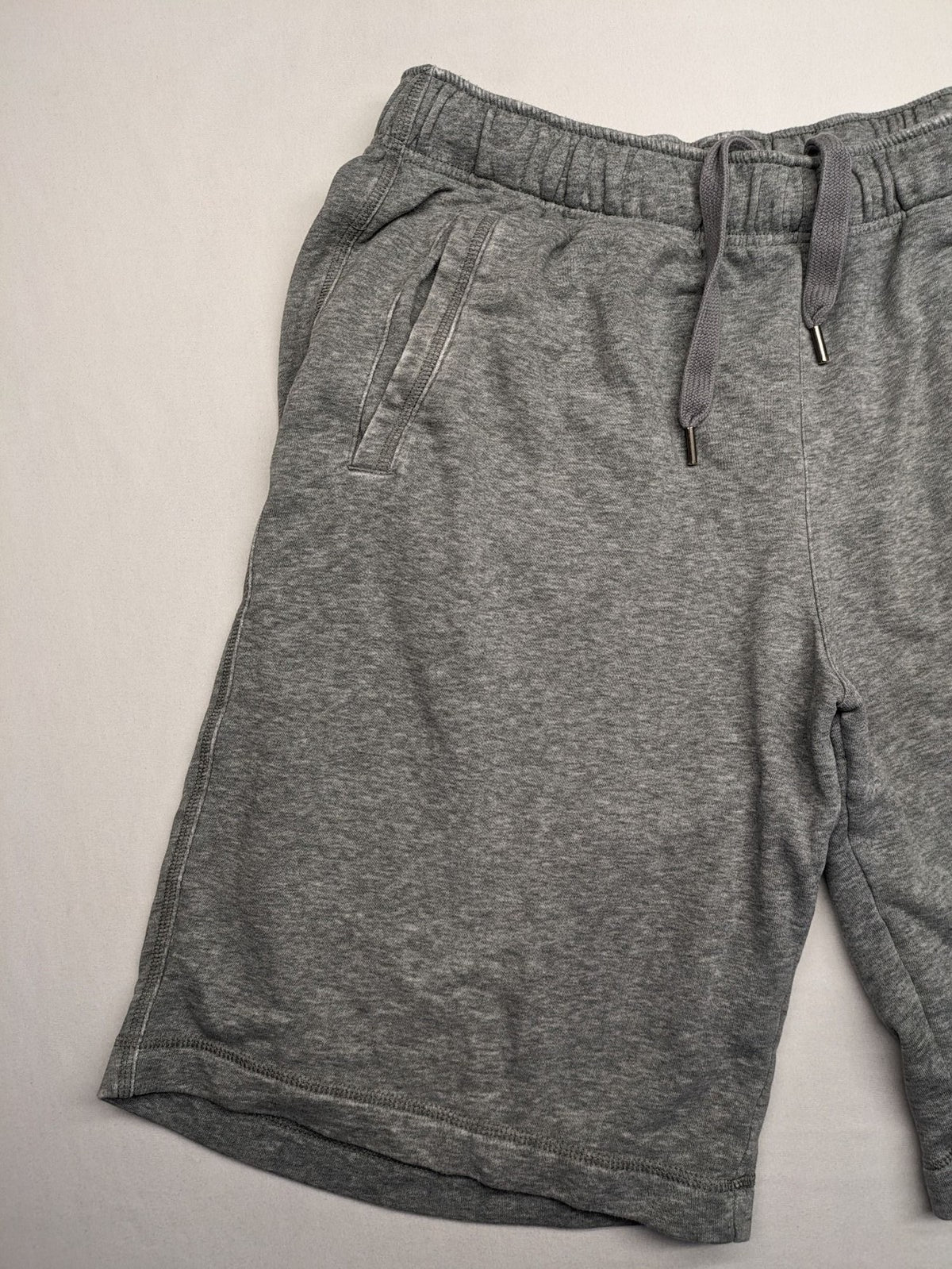 Puma grey sweat shorts with embroidered logo, made from cotton-polyester blend.