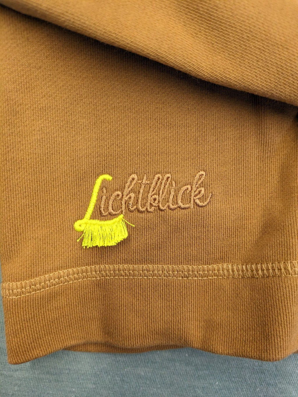 ALS orange crop top sweatshirt with roll neck and embroidered Lichtblick logo.