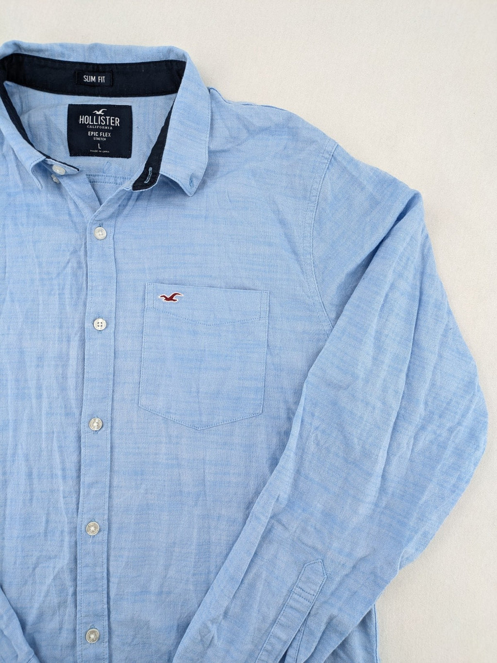 Hollister blue button-down shirt slim fit with embroidered logo and chest pocket.