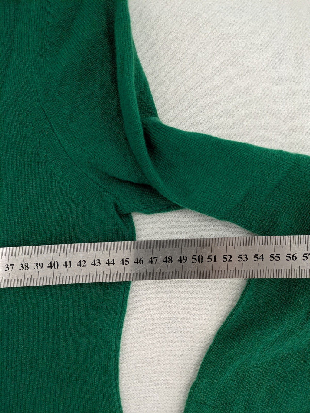 Pullover green cashmere turtle neck jumper with classic V-neck and long sleeves.
